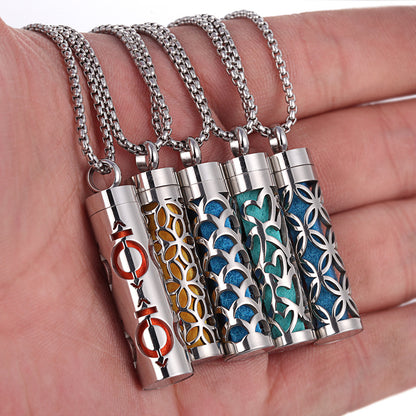 Multiple premium aromatherapy essential oil diffuser pendant necklaces with colorful designs held in hand, showing titanium stainless steel construction