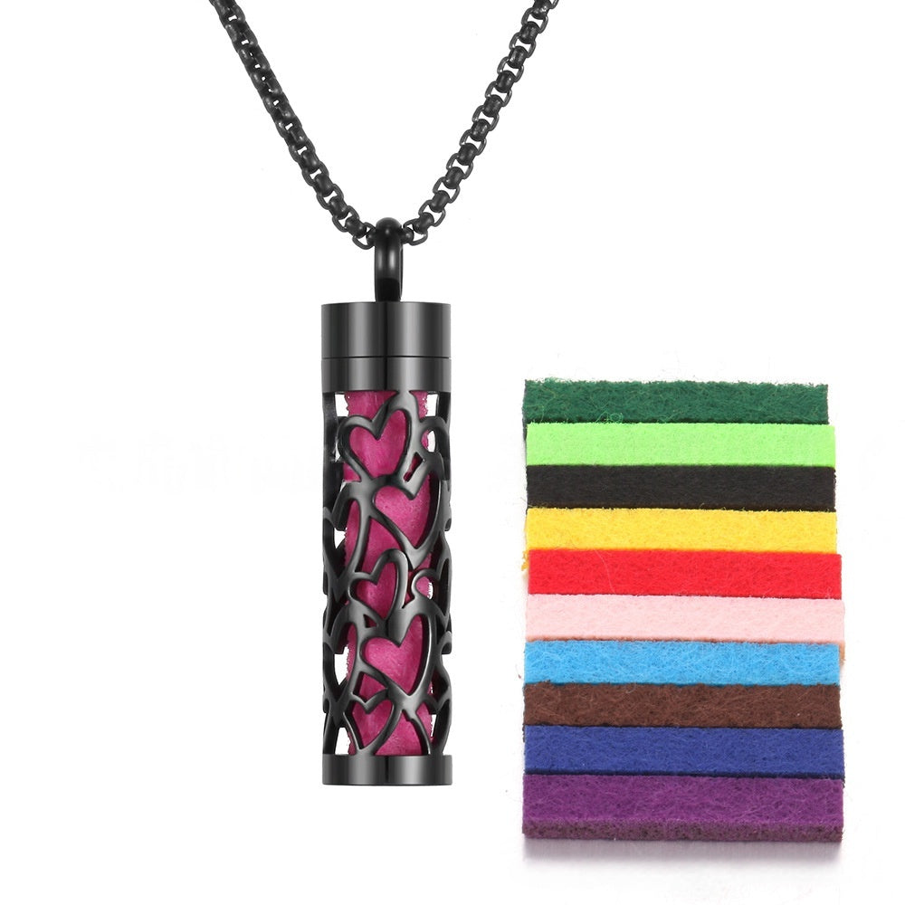 Premium aromatherapy diffuser pendant with pink heart design on black titanium stainless steel body
