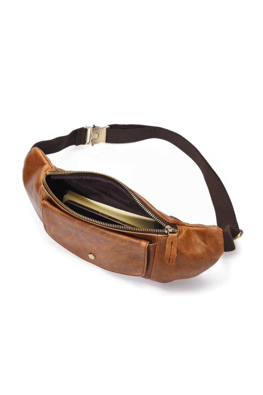 Tan full-grain leather sling bag unzipped, showing the lined interior and adjustable webbing strap