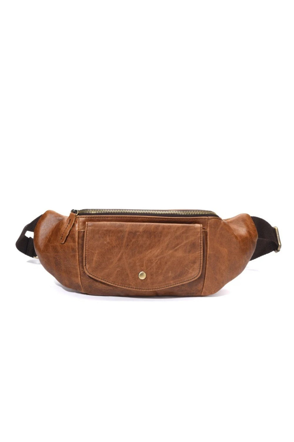 Side view of the closed tan vegetable-tanned leather crossbody chest bag on a white background