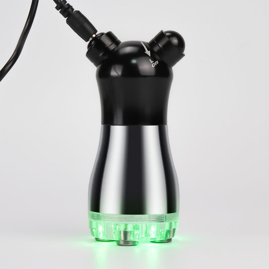 RF & LED Photon Facial Massager plugged in and glowing green during use